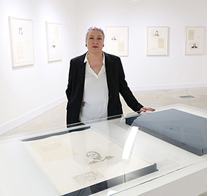 Photograph of Amanda Dunsmore in her exhibition MEMENTO-AGREEMENT, Ulster University Gallery, 2023.