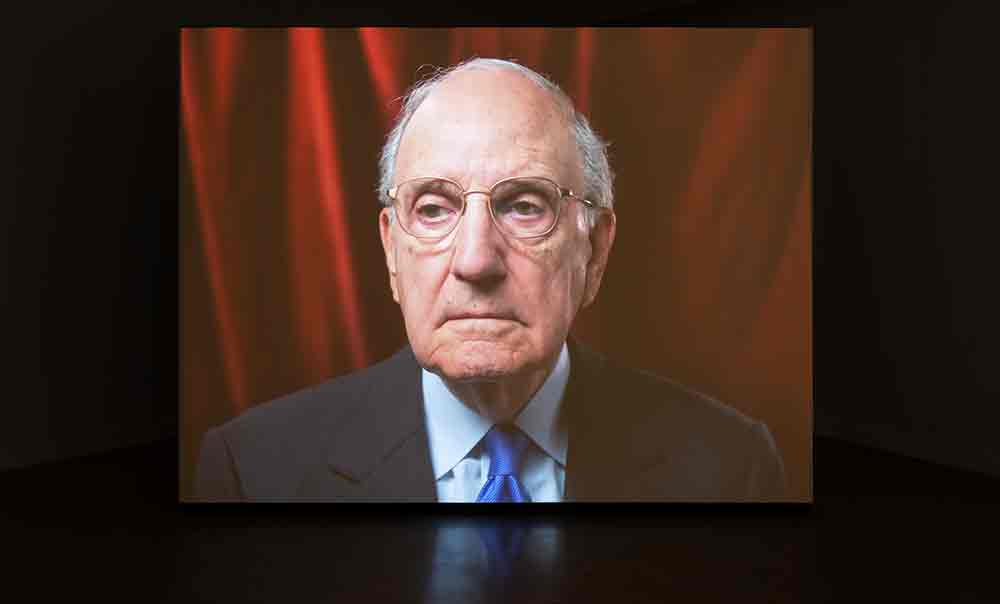 Installation view of Senator George Mitchell's filmed portrait, MAG Gallery, MacEwan University, Canada, 2024.